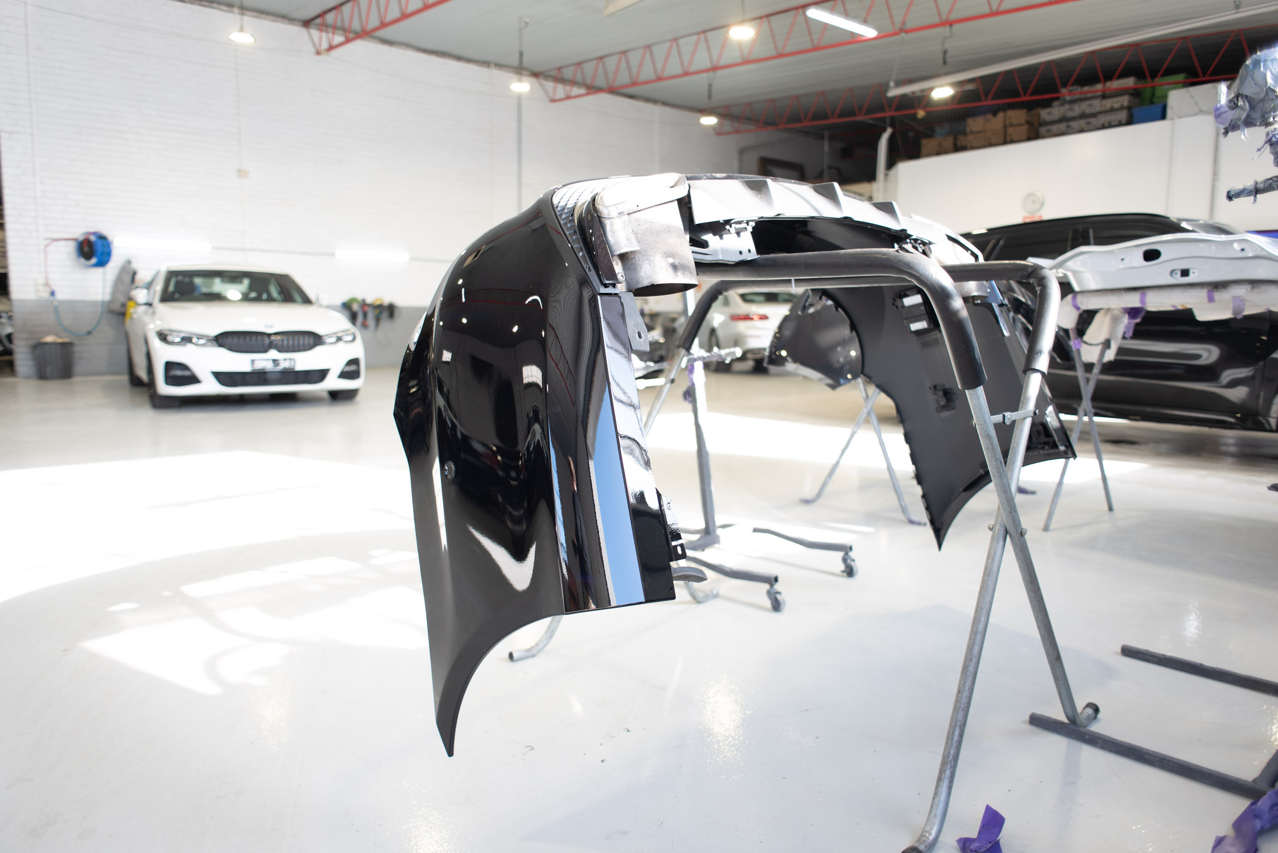 Removed bumper cover on a stand, prepared for repair and refinishing
