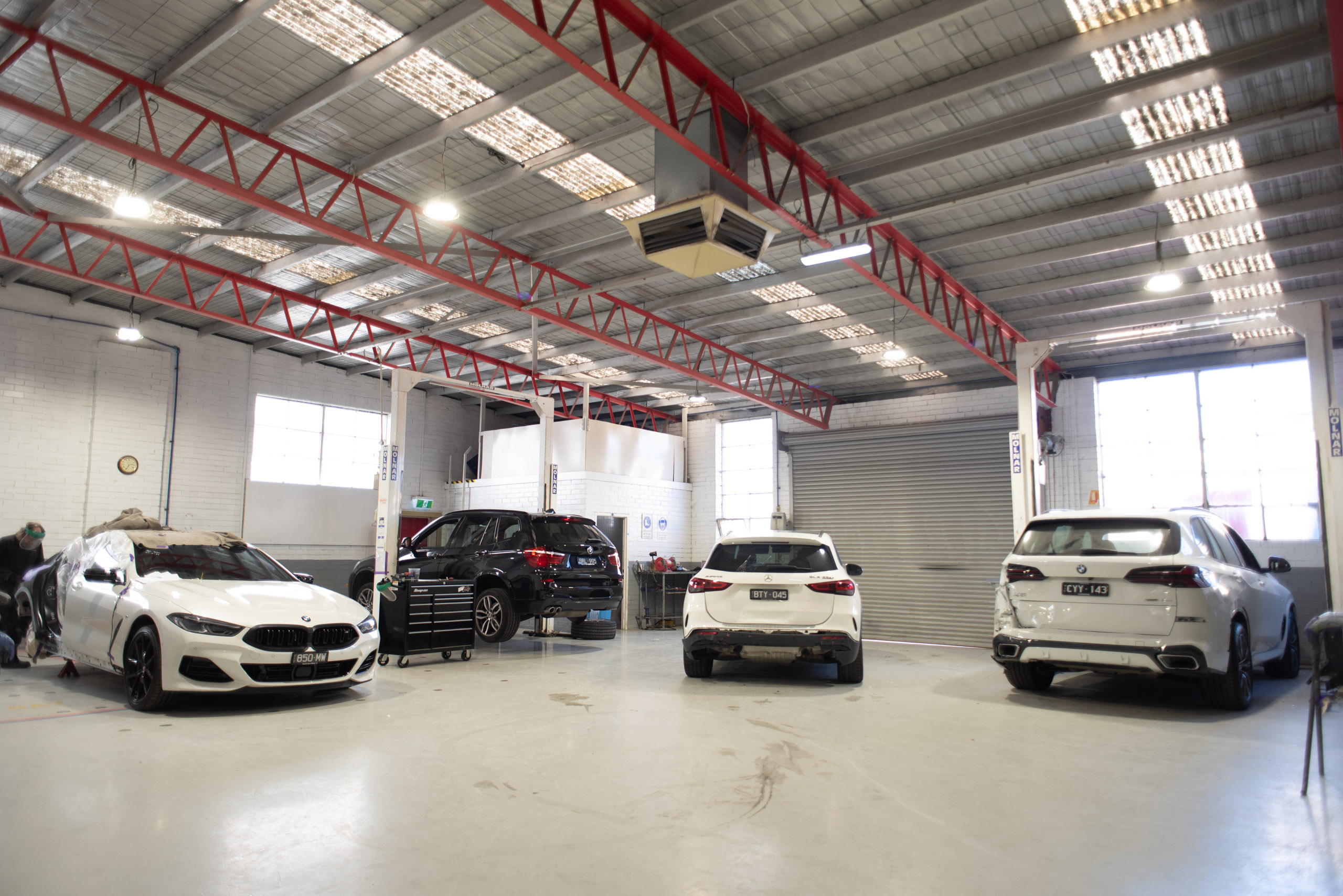 Prestige collision repair workshop with vehicles in for repair