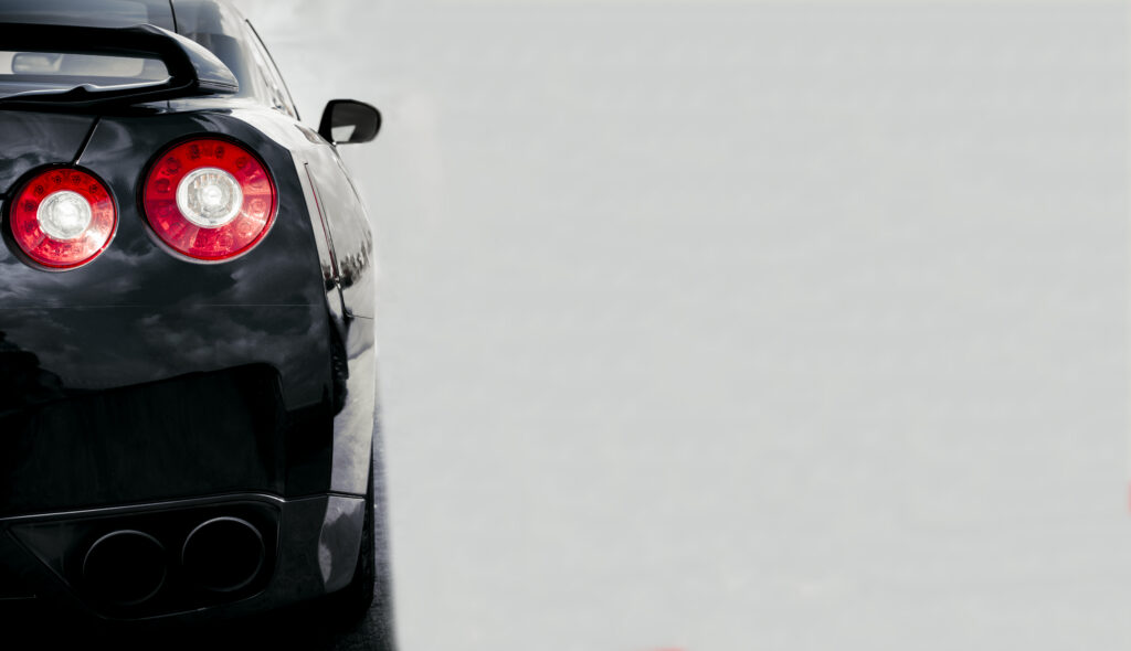 sleek black car with red taillights 2026 03 10 03 06 16 utc