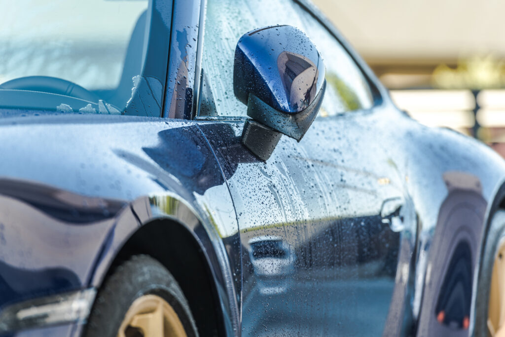 luxurious blue car exterior with water droplets 2026 09 24 12 38 58 utc